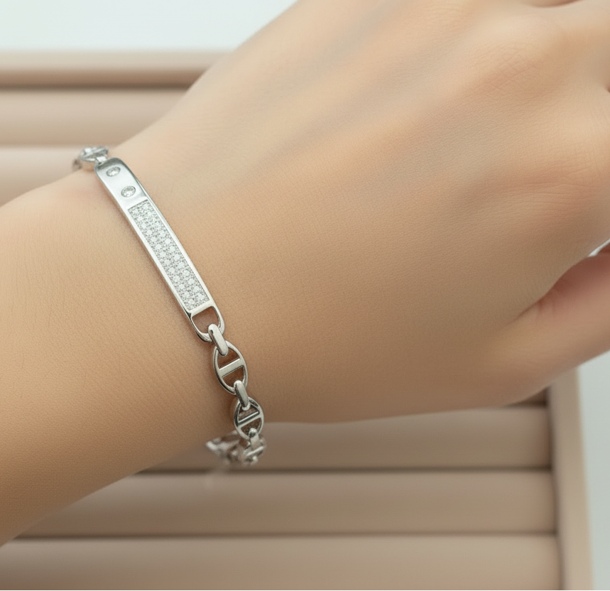Silver bracelet with diamond accents on a beige fabric background