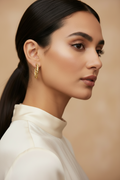 Gold hoop earring on a piece of wood