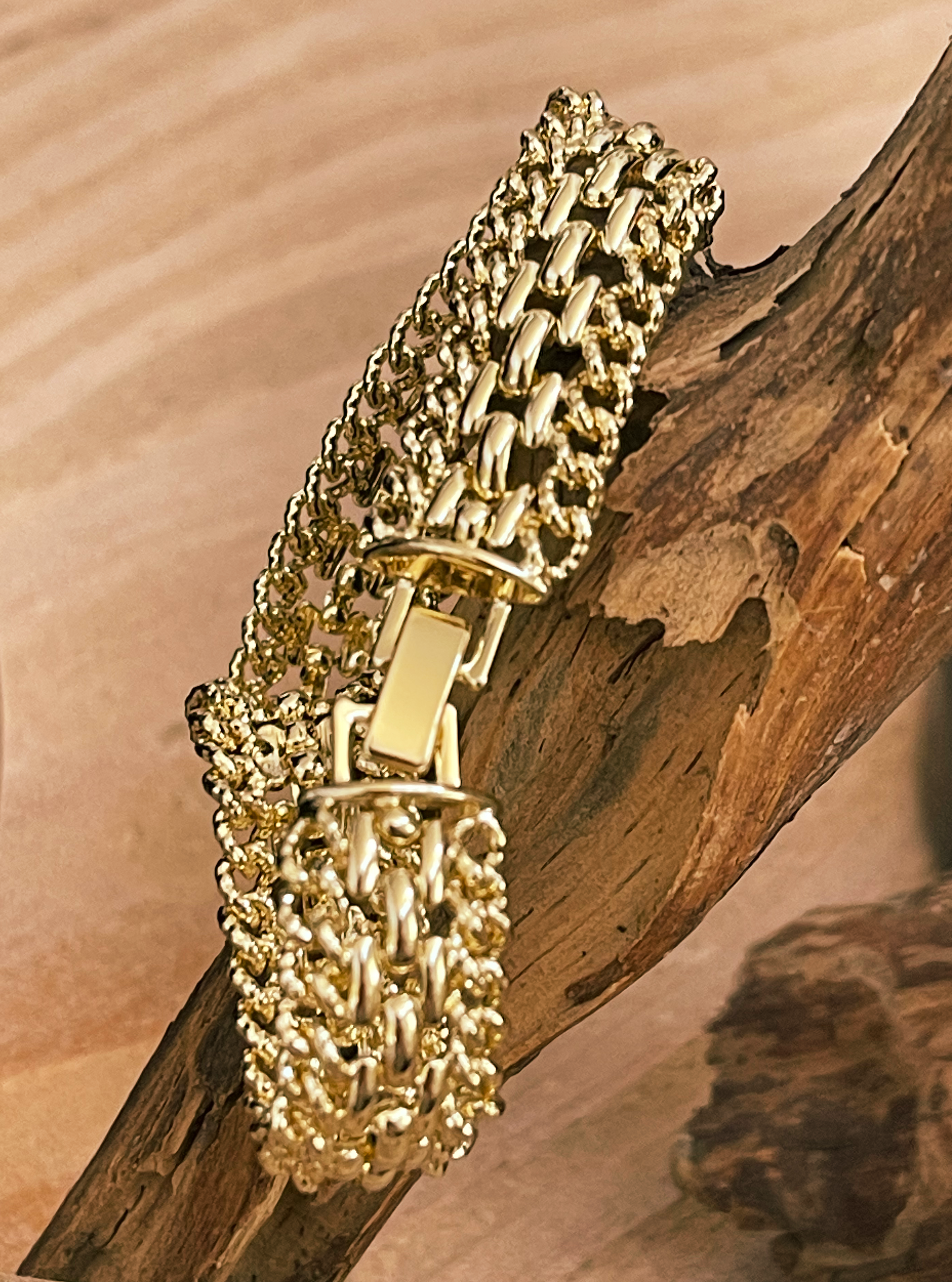 Gold chain bracelet on a wooden surface