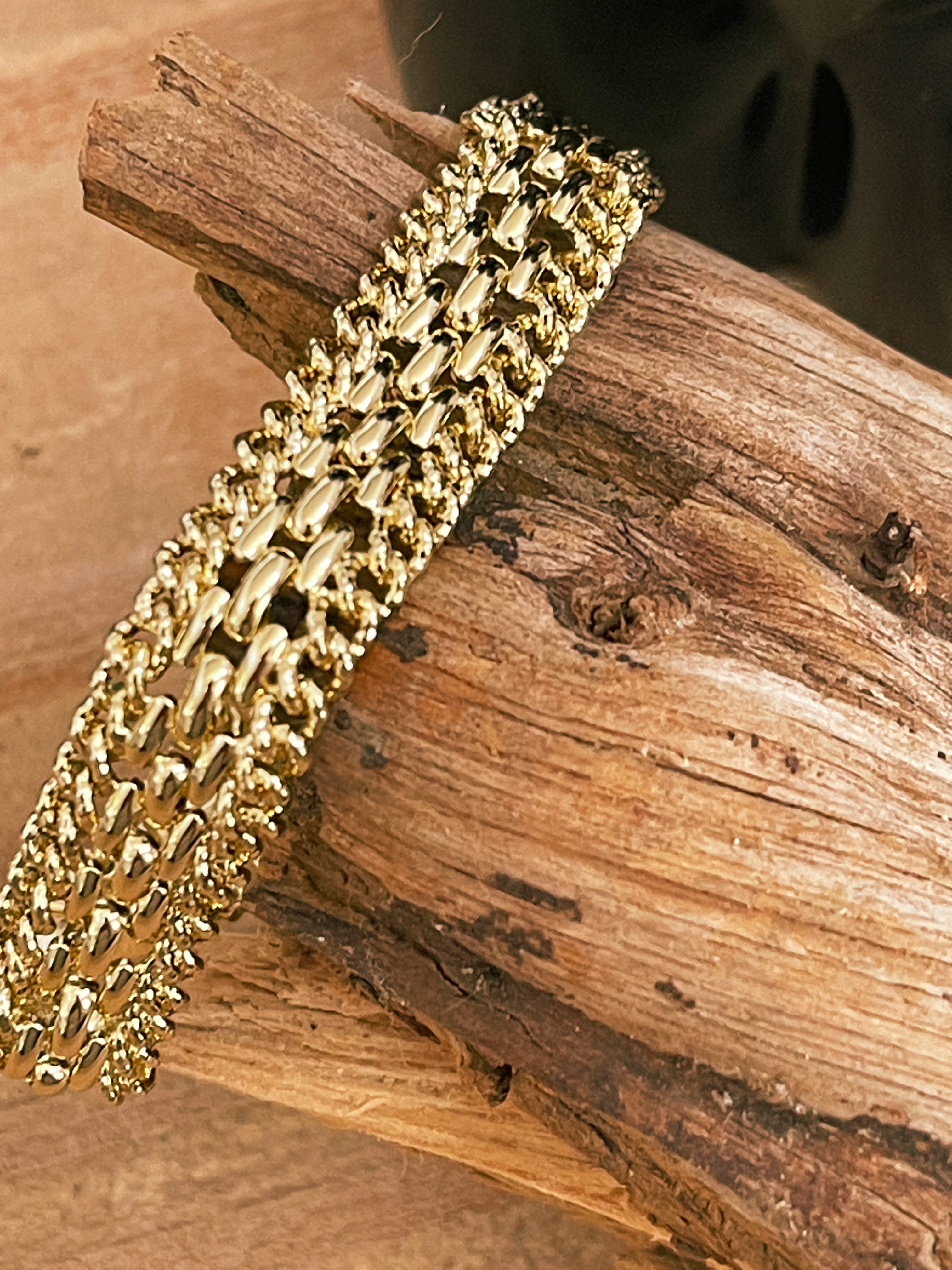 Gold bracelet on a wooden surface